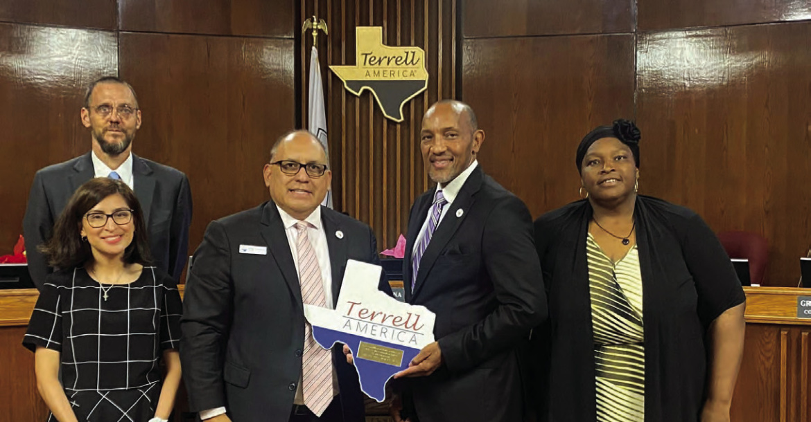 Terrell Mayor Rick Carmona (middle) presents Grady Simpson (second from right) with a plaque in honor of his service as representative for District 2 during their council meeting May 7. Pictured with Simpson are City Manager Mike Sims (back, from left), Mayrani Velazquez and Stephanie Holmes-Thomas. Photo courtesy of City of Terrell