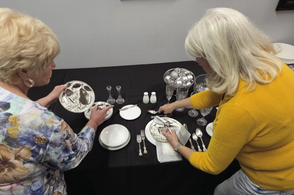 Kathie White (left) and Gerrie Huthmacher check out the Ballard Collection of Noritake china to prepare the BFTS Museum’s tablescape for the Terrell Social Science Club’s Tour of Homes on December 6. Photo courtesy of Liz Oliphant