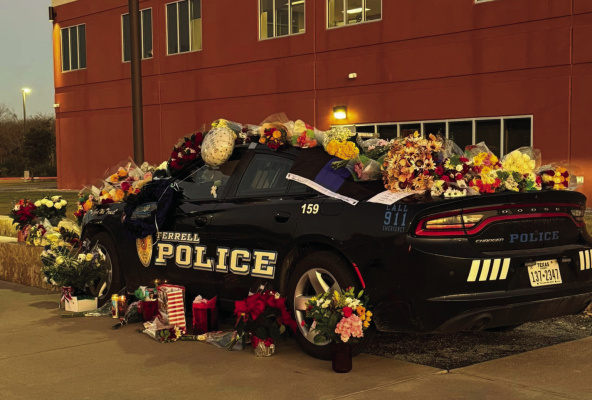 The Terrell Police Department has set up a memorial at their headquarters to honor fallen officer Jacob Candanoza, who was shot and killed in the line of duty on Sunday, Dec. 8. Flowers, notes and other items were placed on the Terrell PD squad car to honor Candanoza. Photo courtesy of Terrell Police Department