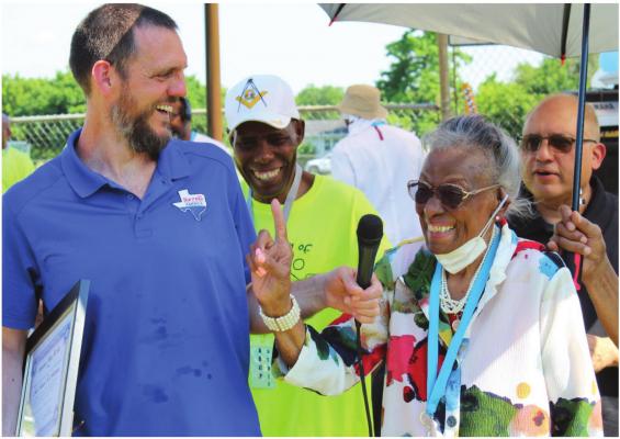 Former Terrell Mayor Frances Anderson shares a smile with City Manger Mike Sims, left; Harold Wilson, background; and Mayor Rick Carmona, right, as she prepares to deliver Juneteenth remarks at Breezy Hill Park. HANK MURPHY PHOTO