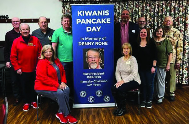 Terrell Kiwanis Club members surround their new banner at a recent meeting, honoring the life of late member Denny Rohe who passed away in January as they prepare to celebrate Kiwanis Pancake Day. Photo by Mary Dlabaj