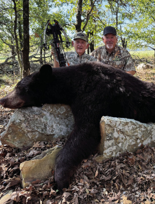 David Cotton, right, and his Dad, Edgar, show one of two black bears taken last week in Southeast Oklahoma at the Choctaw Hunting Lodge. Photo by Luke Clayton