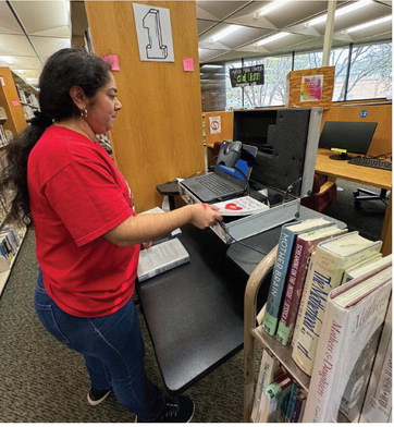 Hulsey Public Library technician Oralia DeLa paz encodes a non-fiction book into the system software using the RFID technology purchased from Tech Logic. Courtesy photo