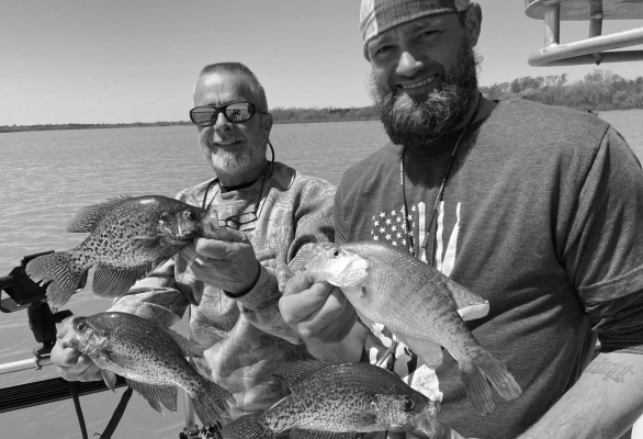 Retired Lake Lavon crappie guide Billy Kilpatrick, left, and guide Brandon Sargent with Lead Slingers Guide Service show off some nice crappie landed last week. Photo by Luke Clayton