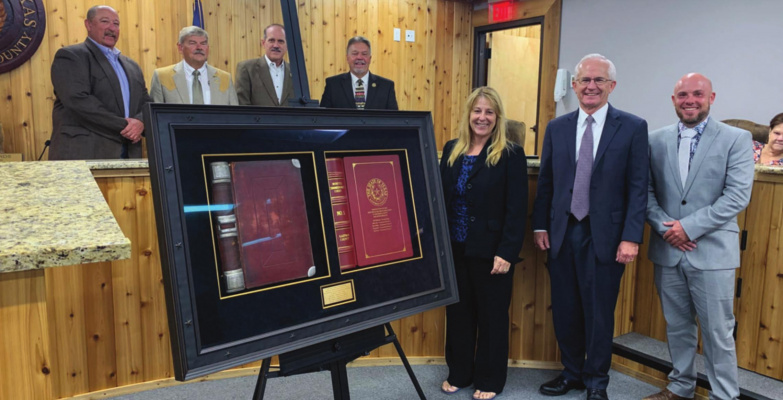 The Kaufman County Commisioners Court, represented by commissioners Mike Hunt, Skeet Phillips, Terry Barber, Ken Cates, county clerk Laura Hughes and Kaufman County Judge Hal Richards, accepted an historical records display gifted to the county by KoFile at their Aug. 10 meeting. COURTESY PHOTO