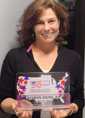 Robin Dunlap with her award signifying membership in The 50 States Marathon Club. Courtesy photo