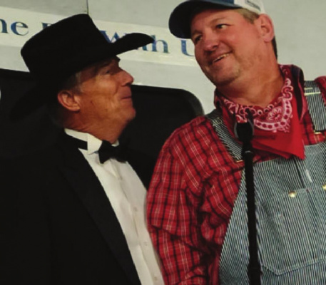 Dressed as a train engineer, Wayne Babovec, right, chairman of the Terrell Chamber of Commerce, shares a light-hearted moment with auctioneer Pat Long during the 40th annual Terrell Civic Auction, which took place Saturday night at the city’s aircraft hangar. The theme for the evening was “Planes, Trains and Automobiles.” About 600 tickets were sold for the event, and the chamber was expected to meet its fundraising goal of $180,000. HANK MURPHY PHOTO