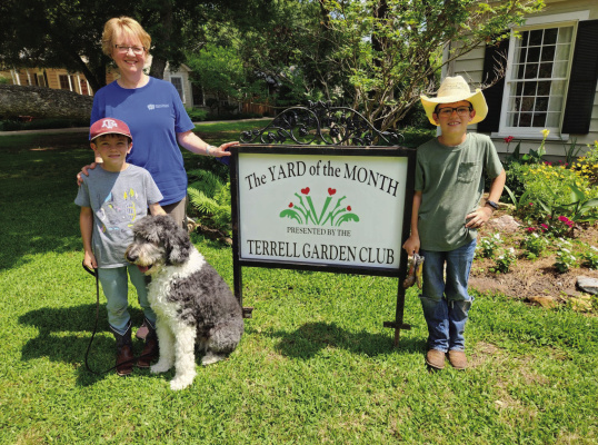 The Terrell Garden Club Yard of the Month is the home of Drake and Barb Torp-Pedersen located at 210 Elm Drive in Terrell. Pictured are Barb Pedersen and helpers Jacob and Caleb Hein, along with dog, Macy. Courtesy photo