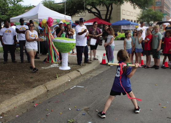 A small child attempts to smash a piñata during the Terrell Taco Festival, which returns to Historic Downtown on Saturday, May 4 from 11 a.m.-4 p.m. Photo courtesy of Terrell Chamber of Commerce