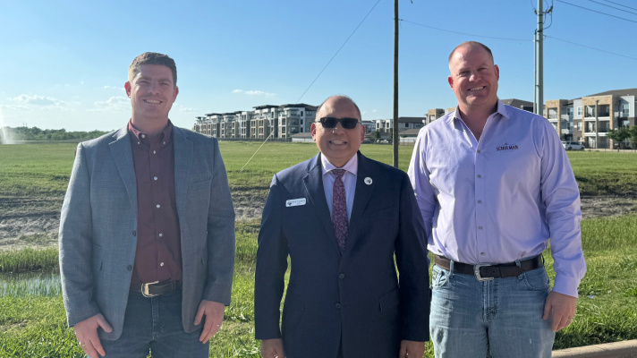 Terrell Mayor Rick Carmona (center), and Schulman Vice Presidents Nathan Schulman (left) and Jacob Schulman stand in front of the land that is the site for their new music venue and restaurant at Crossroads. The indoor/outdoor entertainment venue, behind Film Alley, is expected to open in 2027. Photo courtesy of City of Terrell