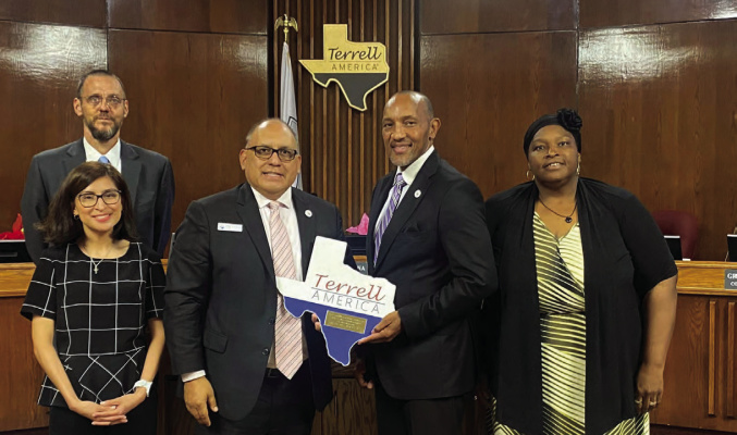 Terrell Mayor Rick Carmona (middle) presents Grady Simpson (second from right) with a plaque in honor of his service as representative for District 2 during their council meeting May 7. Pictured with Simpson are City Manager Mike Sims (back, from left), Mayrani Velazquez and Stephanie Holmes-Thomas. Photo courtesy of City of Terrell