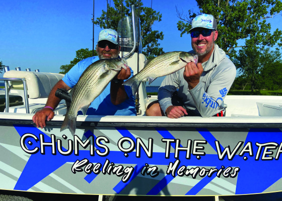 Brett Kilmer, left, and Casey Laughlin with ‘Chums on the Water Guide Service’ show off a couple of hybrid stripers landed with Luke last week at Lake Tawakoni. Photo by Luke Clayton