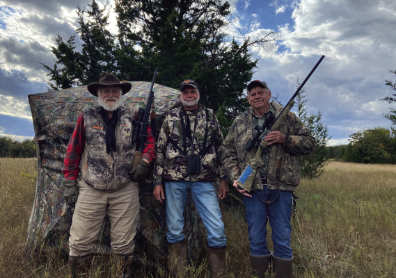 Luke and a couple of his buddies pose with one of the new see through hunting blinds, a relative new hunting product Luke has had great success. Photo by Luke Clayton