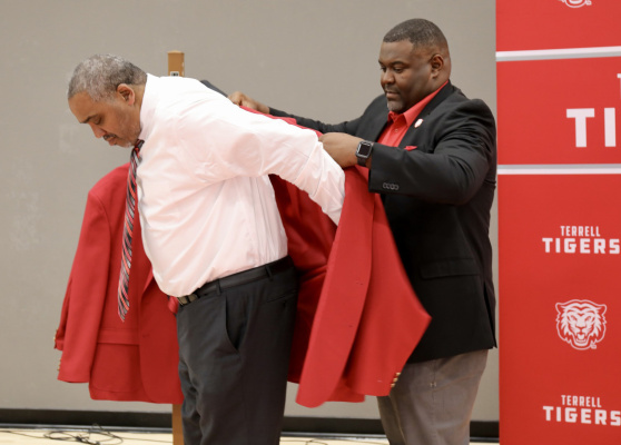 Terrell ISD athletic director and head football coach Marvin Sebderry, Jr. presents Bervin Brown with a red jacket upon the latter’s induction into the Terrell ISD Athletic Hall of Fame. A 1982 graduate of Terrell High School, Brown starred both academically and athletically for the Tigers. Brown would go on to work in finance following graduation before transitioning to coaching. Additional photos on 8B. Photo courtesy of Terrell ISD