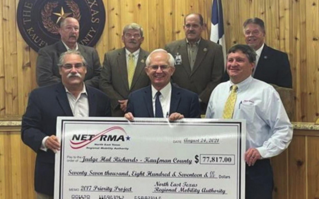 Officials with NET RMA presented the Kaufman County Commissioners Court with a check totaling $77,817 for intersection improvements at SH 243/FM 2727 at their Aug. 24 meeting. COURTESY PHOTO