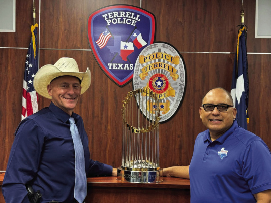 The World Series trophy from the 2023 World Champion Texas Rangers made a visit to the Terrell Police Department Friday, Aug. 29. Pictured with the trophy were Terrell Interim Police Chief Arley Sansom (left) and Terrell Mayor Rick Carmona. Photo courtesy of Terrell Police Department Facebook page