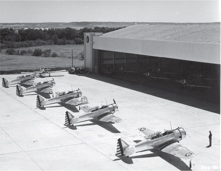 AT-6 trainers near the hangar building are part of the speaker series for The No. 1 British Flying and Training School Nov. 2. Photo courtesy of North American Aviation via Aircraft Manufacturer’s Collection, History of Aviation Collection, Special Collections and Archives Division, Eugene McDermott Library, The University of Texas at Dallas. Copyright (c) Boeing