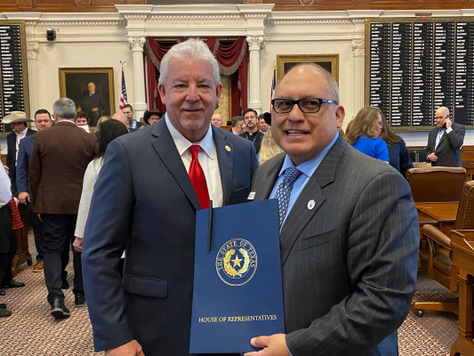 State Representative Keith Bell, left, signed a special resolution recognizing Terrell’s sesquicentennial during Kaufman County Day in Austin Feb. 6. Mayor Rick Carmona, right, was among the local city and county leaders in attendance to mark the occasion. Courtesy photo