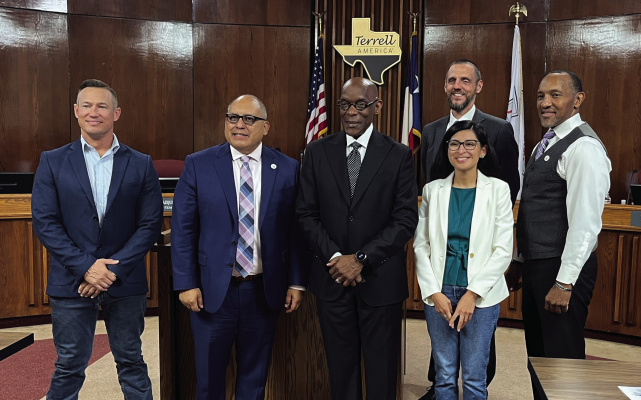 Reverend Richard Rollerson (third from left) is honored with a Terrell 150th anniversary commemorative coin at the Aug. 1 meeting for his service to the community alongside District 5 member Phil Robison (from left), Mayor Rick Carmona, Mayor Pro-Tem Mayrani Velazquez (front), City Manager Mike Sims (back) and District 2 member Grady Simpson. Photo by Bodey Cooper