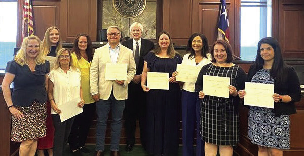 Pictured from left to right: Lauri Dodd, Haley McGee, Lezlie Carvell, Barbi Angott, Beau Winkler, Judge Hall, Julie Tanner, an unnamed volunteer, Nereida Garcia Price and Nevine Carlson are sworn in as Lone Star CASA volunteers July 2 in Rockwall. Courtesy photo