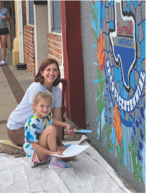 Many come out each year to enjoy the Terrell Mural Walk, set for Sept. 20 this year. This year’s event has an exciting feature where an artist will be painting the original IRIS Theatre marquee sign live on-site during the event. Photo courtesy of Terrell Chamber of Commerce