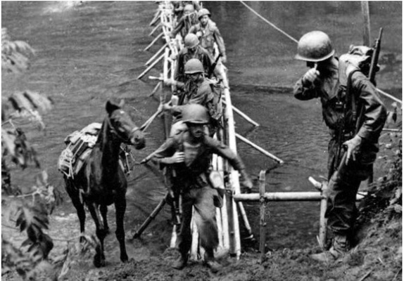Merrill’s Marauders make their way across a bridge during battle in World War II. Photo courtesy of BFTS Museum