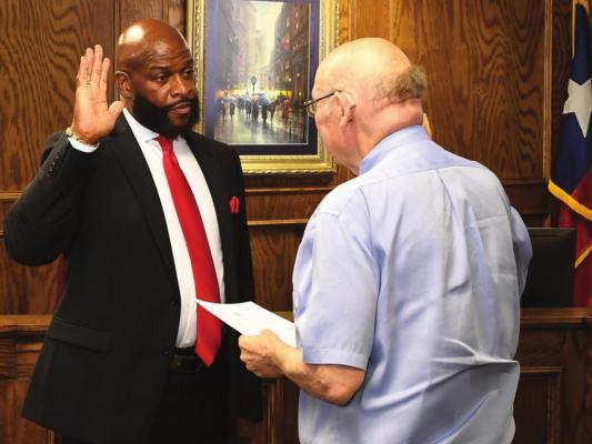 Dr. Terry Eason is sworn in as member of the TVCC Board of Trustees by Judge Randy Daniel. COURTESY PHOTO