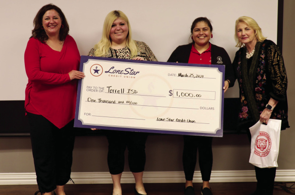 Terrell ISD Superintendent Dr. Georgeanne Warnock (far left) and Terrell ISD School Board President Dena Risinger (far right) stand with Aimee Isaac and Amethyst Hamby of Lone Star Credit Union as they donate a $1,000 check to the Teacher Supply Shop during the Terrell ISD school board meeting March 26. Photo courtesy of Terrell ISD Facebook page