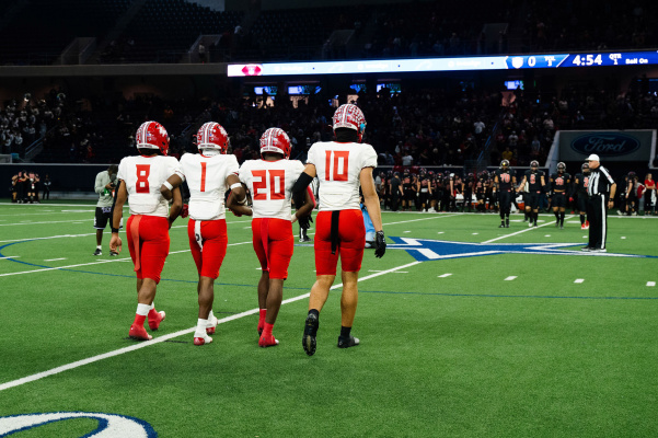 Team captains Terry Davis (8), Kanye Nix (1), Chase Bingmon (20) and Preston Kilgore (10) walk to midfield to meet their counterparts prior to the Regional Quarterfinal contest between Terrell and Melissa Nov. 25 at The Star in Frisco. Melissa would come away with a 42-21 win to advance to the Regional Semifinals. Photo by Michael Arndt