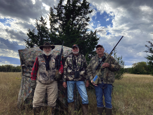 Larry Wieshuhn, Jeff Rice and Luke (left to right) stand in front of a see-through pop-up blind. These blinds have become very popular over the past couple of years. The hunter can see out but game cannot see in. Photo by Don Gresham