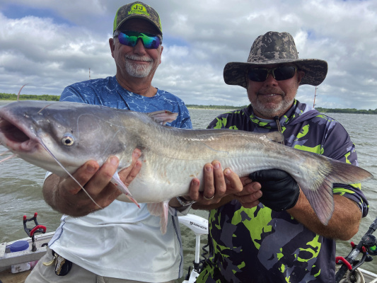 Jeff Rice and Tawakoni catfish guide Tony Pennebaker show off one of many good eating blue catfish landed last week. Photo by Luke Clayton