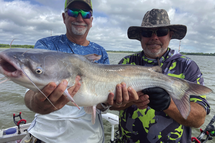 Jeff Rice and Tawakoni catfish guide Tony Pennebaker show off one of many good eating blue catfish landed last week. Photo by Luke Clayton